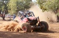 Red car kicking up dust during speed timed trial event